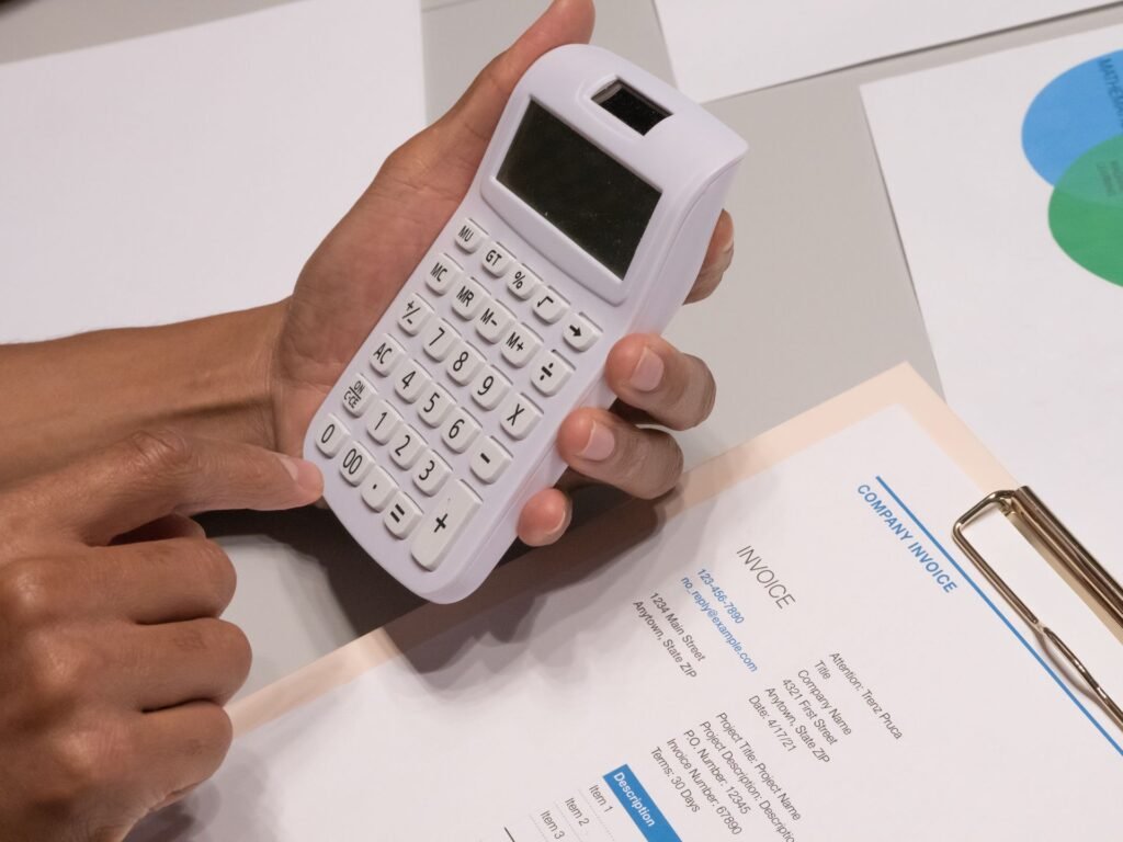 Calculator next to a repair invoice, weighing repair versus replacement