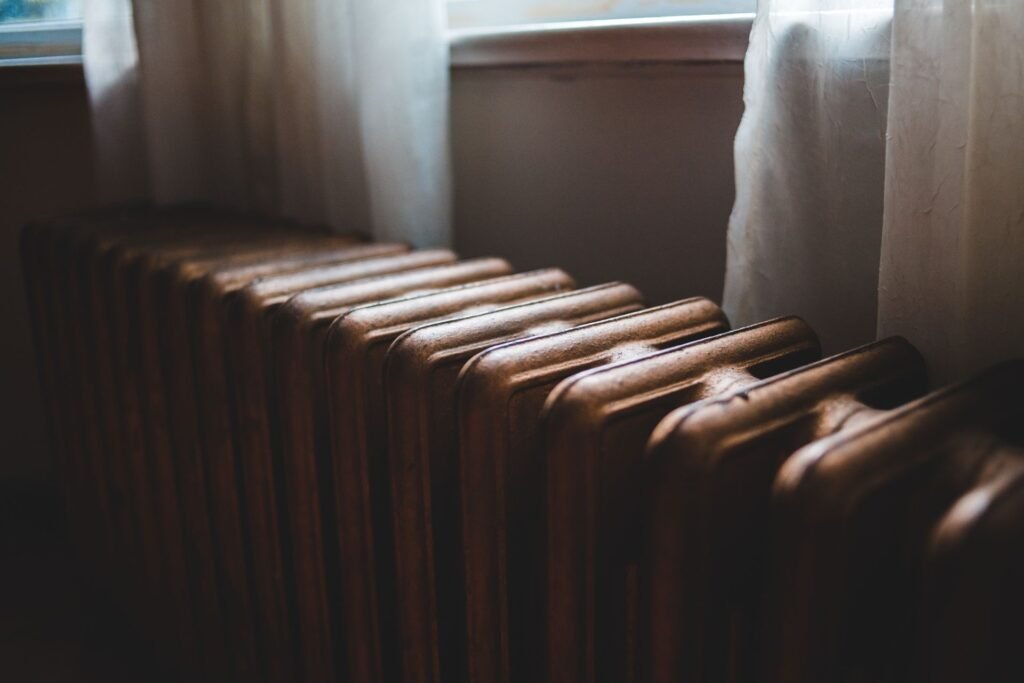 Cast-iron steam radiator under a window in an older home