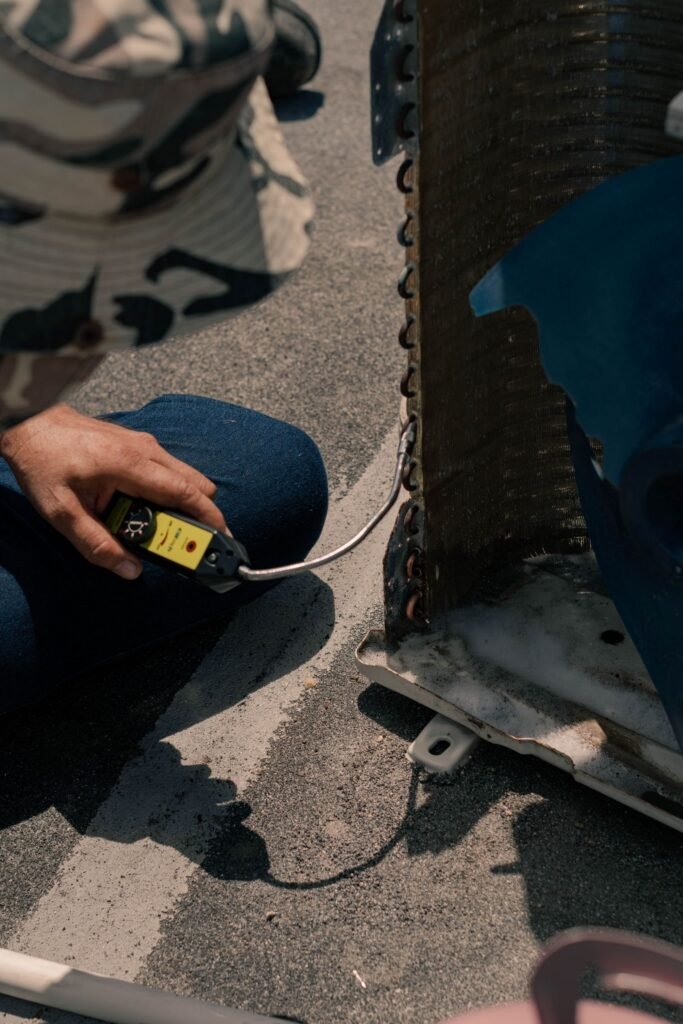 Technician working on an air conditioning condenser