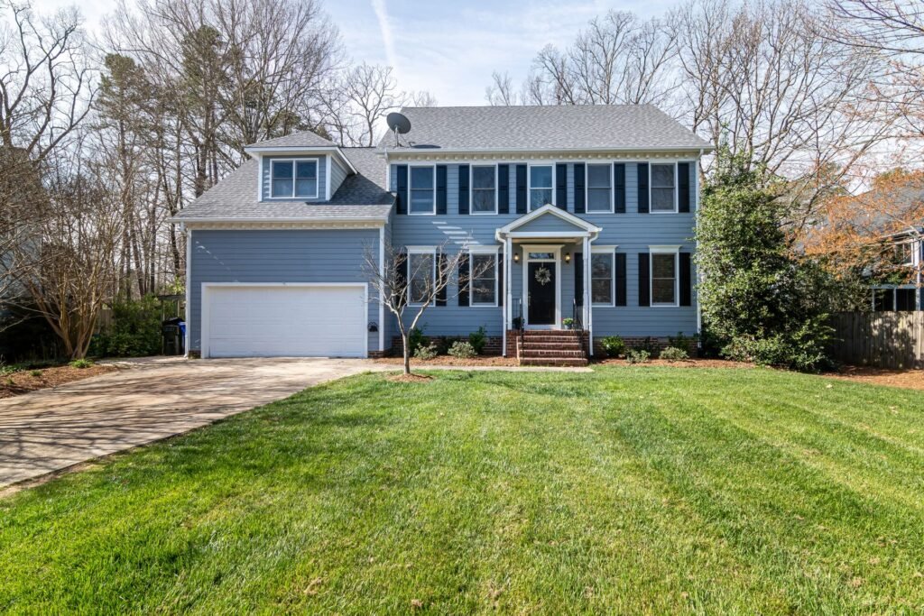 Two-story colonial home with a large lawn, typical of Syosset, NY