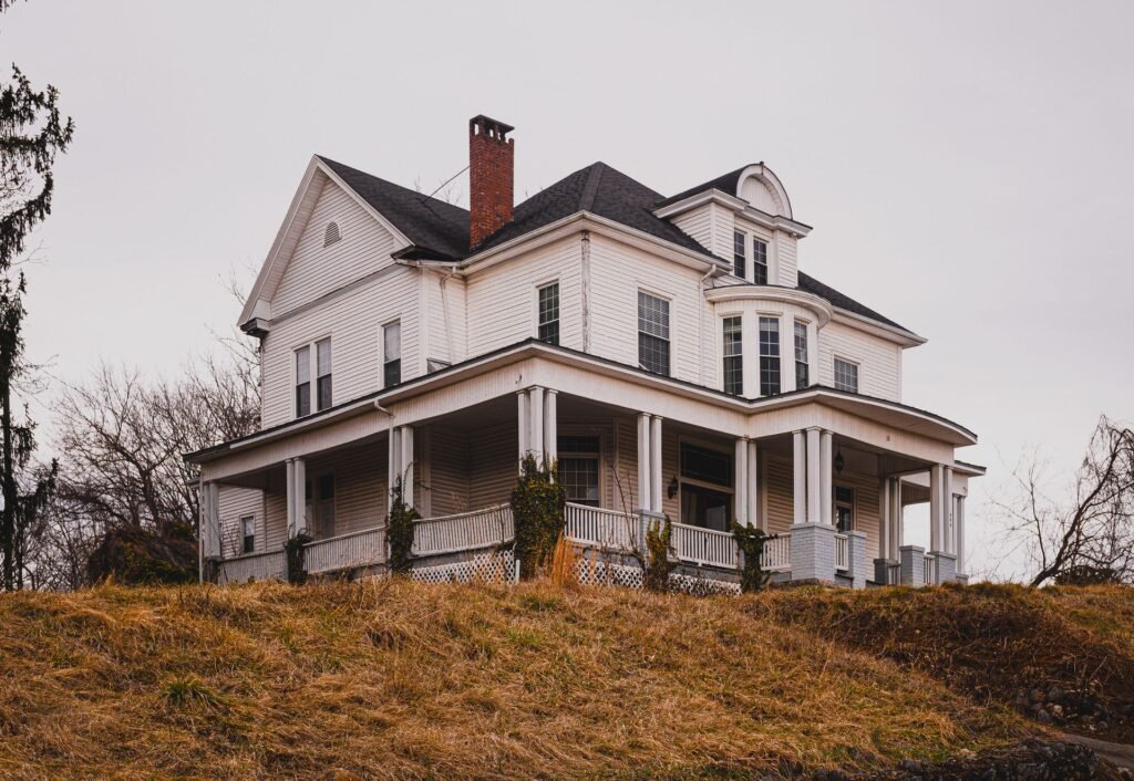 Historic older home with a wraparound porch, like those in the Village of Westbury, NY