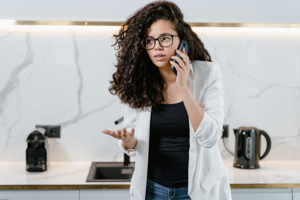Homeowner making a phone call in her kitchen