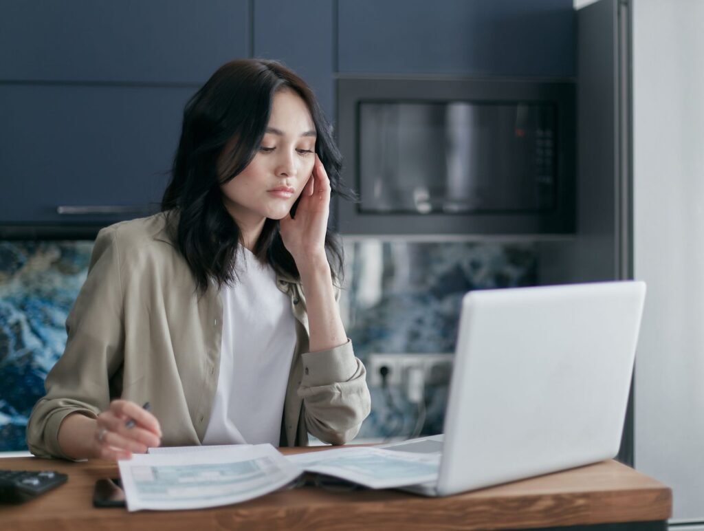 Homeowner researching on a laptop at the kitchen table