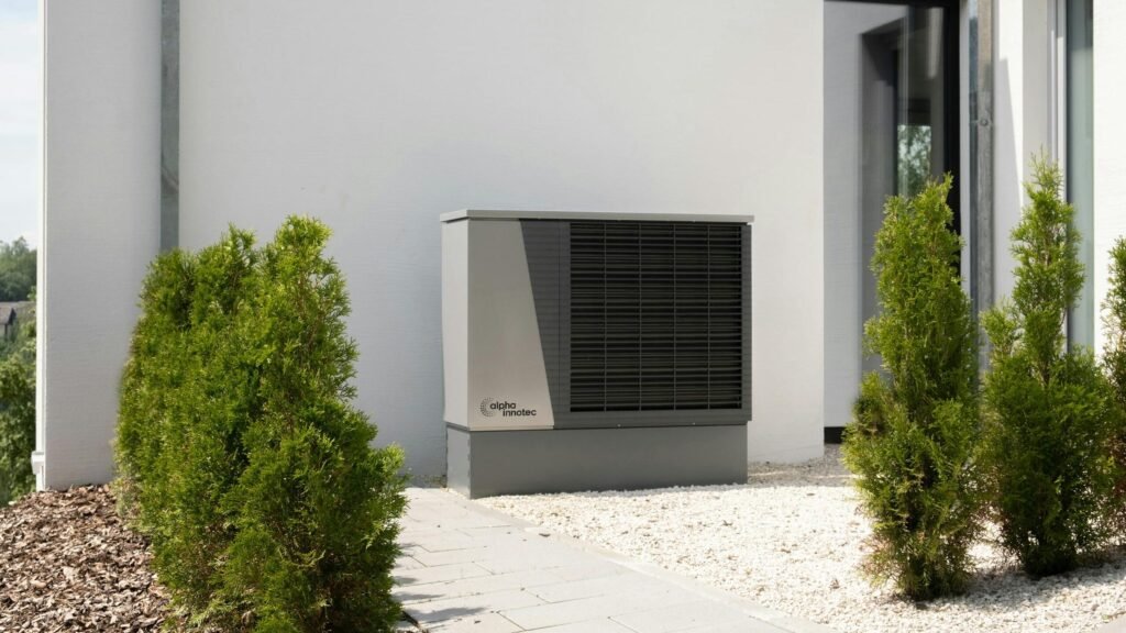 Outdoor heat pump unit installed beside a home