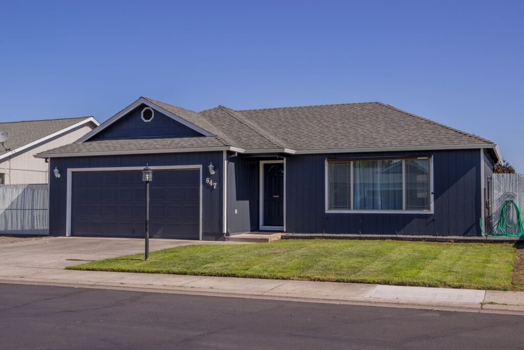Single-story ranch-style house with a driveway, typical of Levittown, NY