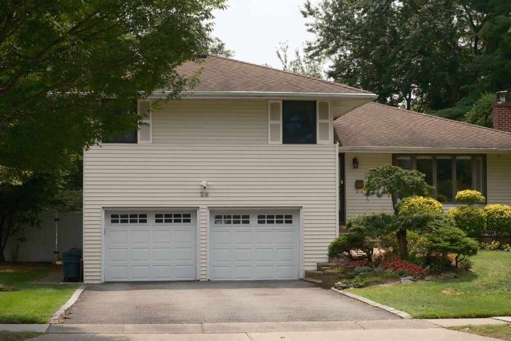 Split-level house with a double garage, typical of Plainview, NY