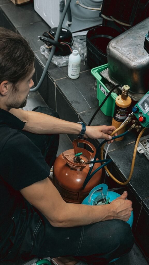 HVAC technician checking refrigerant gauges during an AC repair