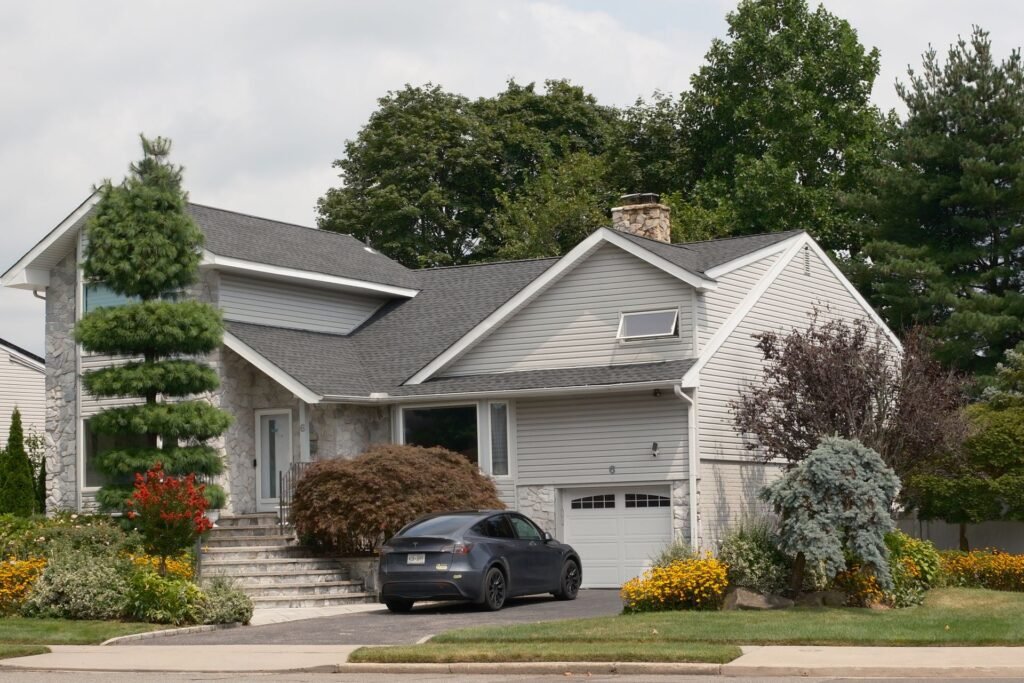 Two-story suburban house with a driveway, typical of Bethpage, NY